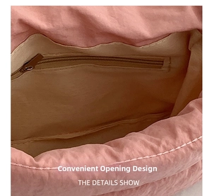 Detail view of pink canvas crossbody bag interior with convenient zipper pocket