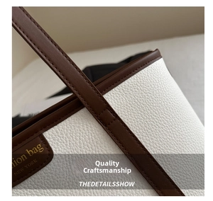 Detail of stitched litchi pattern leather with Fashion Bag New York label on tote bag