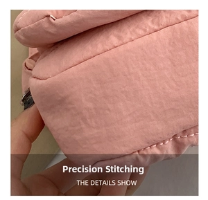 Macro view of tight and precise stitching on the pink quilted fabric crossbody bag