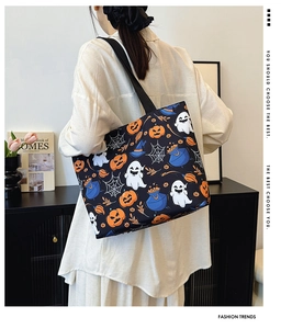 Detail of Halloween ghost and pumpkin prints on a large capacity canvas tote bag