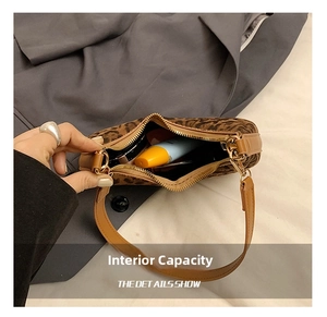 Detailed top view of leopard print shoulder bag interior showing daily essentials storage