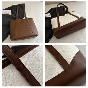 Macro shot of precise stitching and litchi texture on a large leather tote bag