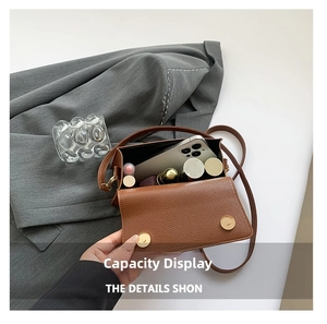 Detail view of brown pebbled leather crossbody bag showing phone and lipstick capacity