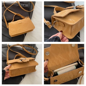 Detailed views of yellow patent leather crossbody bag with pleated texture and silver buckle