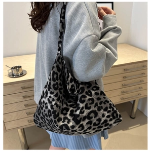 Detail of trendy leopard print knit shoulder bag featuring soft fabric and spacious interior