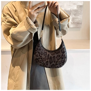 Detailed leopard print crescent bag with plush texture and gold hardware hooks