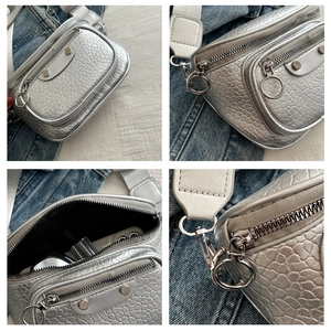 Detail views of silver crossbody bag with crocodile texture and wide fabric strap