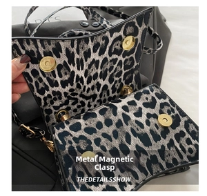 Detail of leopard print handbag showing secure golden magnetic snap closure and black lining
