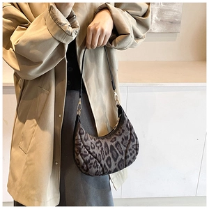 Close-up of leopard print crescent bag with fine velvet texture and top zip closure