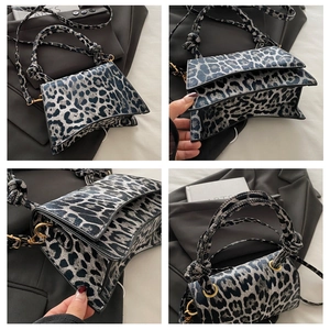 Detailed view of leopard print crossbody bag showing multi-layer inner compartments