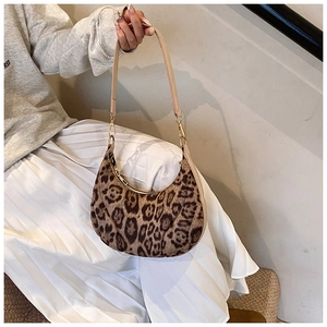 Detail of leopard print crescent bag with plush texture and beige shoulder strap