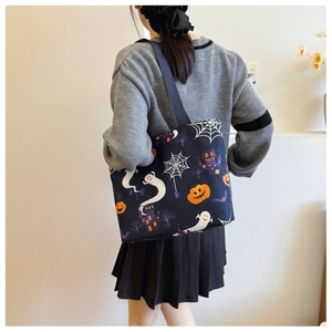 Detail of Halloween ghost tote bag with pumpkin print and purple castle patterns