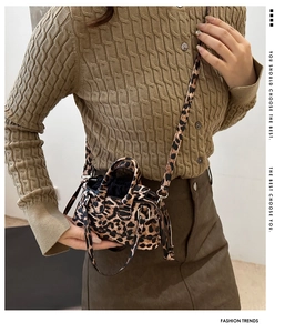 Detailed view of leopard print mini lipstick bag with crossbody strap and inner drawstring