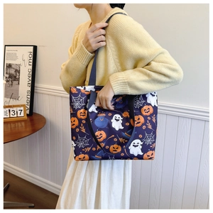 Detailed view of Halloween tote bag with pumpkin and ghost prints on a purple background