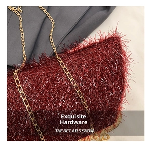 Detailed view of luxury wine red faux fur handbag featuring elegant gold metal chain strap