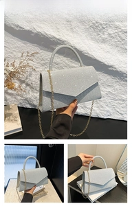 Detail of silver rhinestone square clutch with envelope flap and gold chain strap
