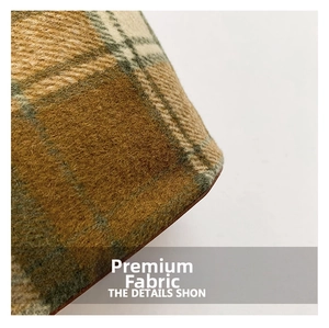 Macro detail of the vintage brown plaid wool fabric and texture on the shoulder bag