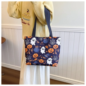 Close-up of Halloween tote bag with spooky ghost and pumpkin prints on purple canvas