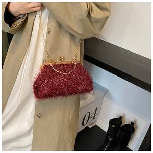 Detail of red glitter chain shell bag with plush texture and vintage gold clasp closure