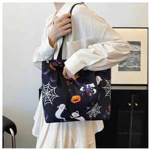 Detail of Halloween tote bag with ghost, pumpkin, and castle prints on black fabric