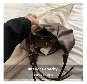 Spacious interior of brown soft leather tote bag showing storage for daily essentials