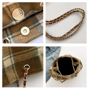 Detail view of brown plaid bucket bag showing metal chain strap and magnetic snap closure