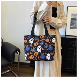 Detail of Halloween tote bag featuring pumpkin, ghost and witch hat patterns on canvas