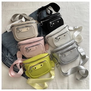 Flat lay of litchi texture crossbody bags in six colors with wide adjustable straps