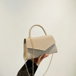 Champagne gold glitter evening clutch bag with circular handle and metal chain strap