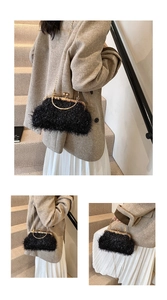 Detail of black plush chain shell bag with golden metal frame and handle for women