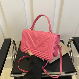 Pink minimalist crossbody bag with V-shaped quilting and top handle for women