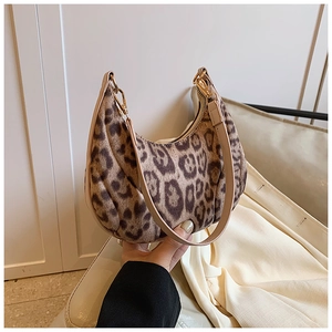 Detail view of leopard print crescent bag with soft faux fur texture and gold zipper