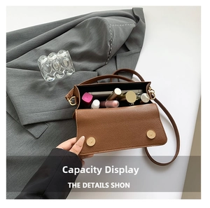 Interior view of brown lychee leather crossbody bag showing cosmetic storage capacity