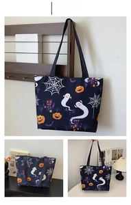 Detail of blue Halloween tote bag featuring pumpkin, ghost, and castle illustrations