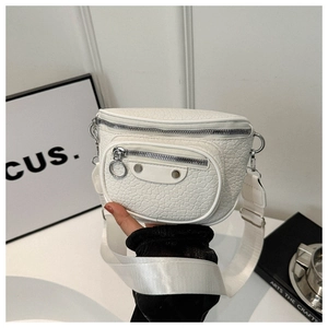 Detail view of white lychee leather sling bag with silver rivets and moto hardware