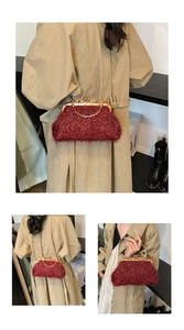 Close-up of red glitter evening shell bag with gold metal clasp and chain strap