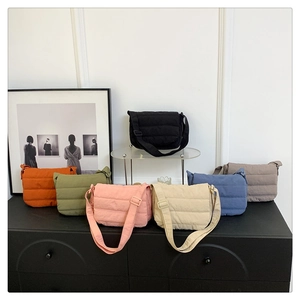 Detailed display of quilted crossbody bags in seven colors like black, green and beige