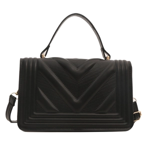 Minimalist black quilted crossbody bag with V-shaped stitching and gold metal hardware