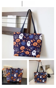 Detail of blue Halloween tote bag with pumpkin, ghost, and witch hat print patterns