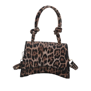 Fashionable leopard print handbag with unique curved bottom and decorative knot handle