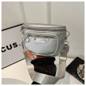 Silver metallic crossbody bag with textured leather, rivet details, and wide nylon strap