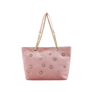 Pink velvet tote bag with gold metal studs and chain strap on a white background