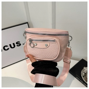 Close-up of pink textured faux leather crossbody bag with silver hardware and wide strap