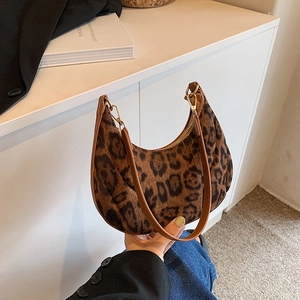 Fashionable leopard print crescent bag with brown leather strap and golden zipper