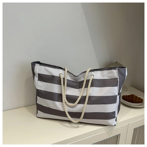 Detail of grey and white striped canvas tote bag with thick cotton rope handles
