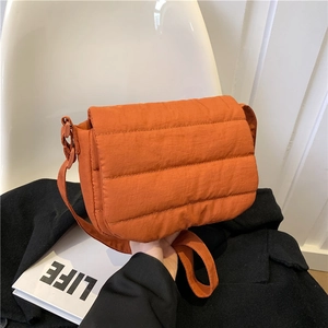 Orange quilted puffer crossbody bag with flap and adjustable strap for casual autumn style