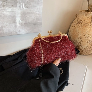 Elegant wine red shell crossbody bag with metallic gold handle and plush fiber texture