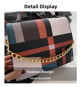 Detail shot of vintage plaid crossbody bag with golden chain and luxury texture