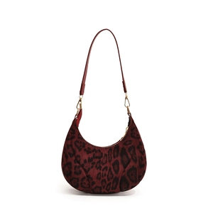 Chic burgundy leopard print crescent underarm bag with gold zipper and velvet texture
