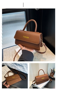 Detailed view of the brown lychee pattern leather texture and gold metal buckle hardware